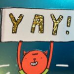 A cartoon creature holds up a sign that says "YAY!" in sparkly letters.