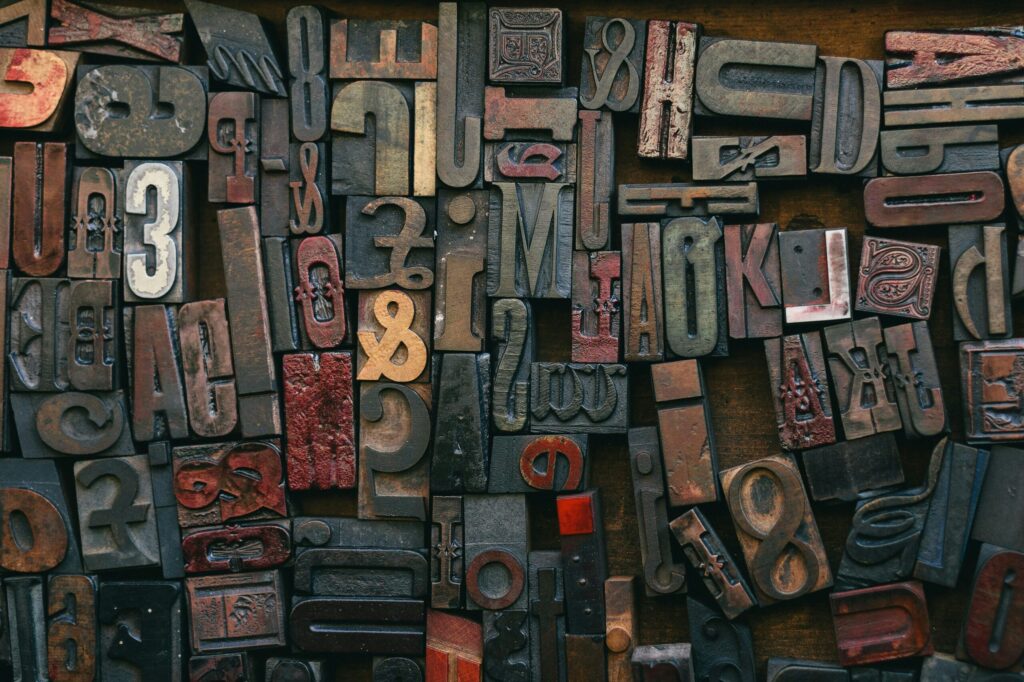 Blocks with letters, numbers, and symbols carved into them - in reverse, for printing