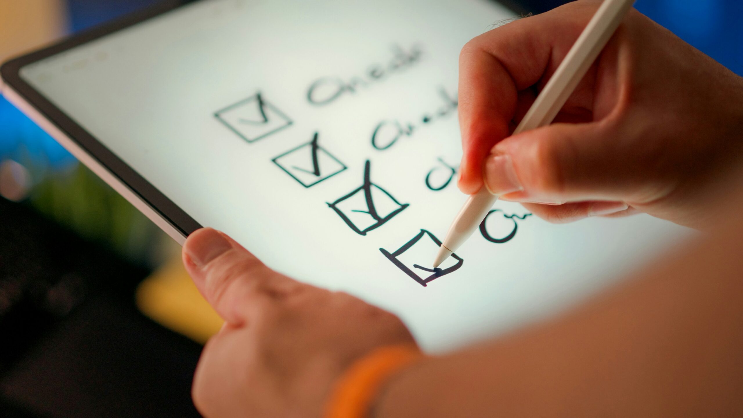 A person checking boxes on a tablet where each box is labeled "Check"
