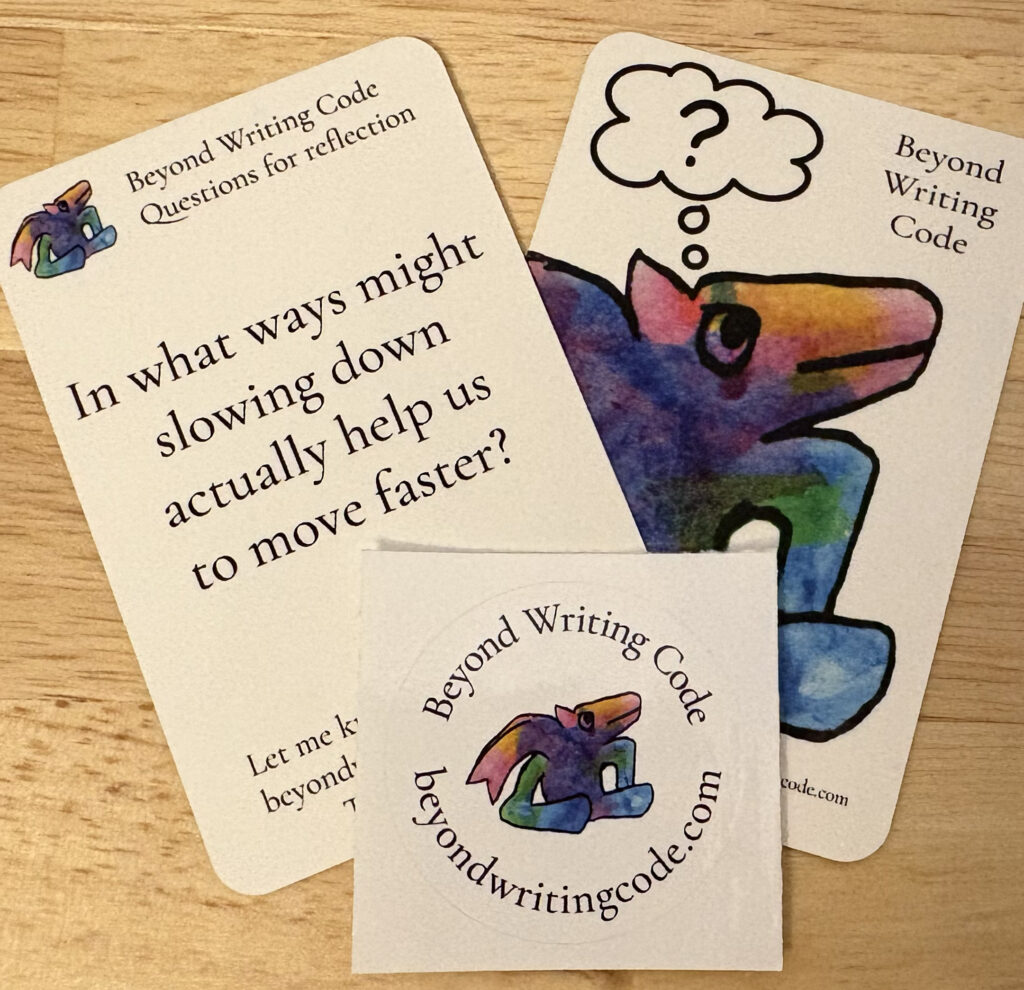 Two business cards and a small round sticker. One card says "Beyond Writing Code Questions for reflection" and "In what ways might slowing down actually help us to move faster?" The other card says Beyond Writing Code and has a watercolor and ink drawing of a creature with a thought balloon that just has a question mark. The sticker has the same watercolor creature and the text "Beyond Writing Code" and "beyondwritingcode.com" around it.